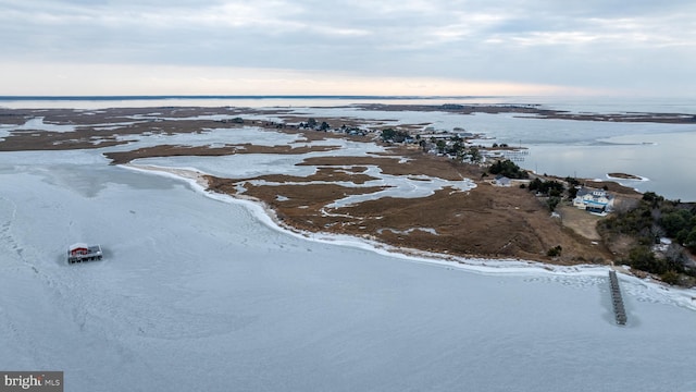 snowy aerial view with a water view