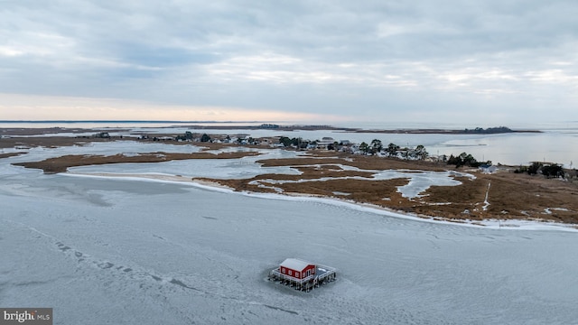 birds eye view of property with a water view and a beach view