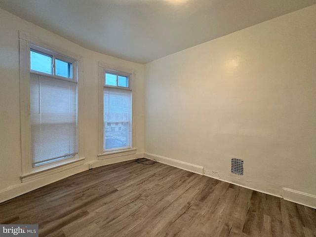 unfurnished room featuring hardwood / wood-style floors