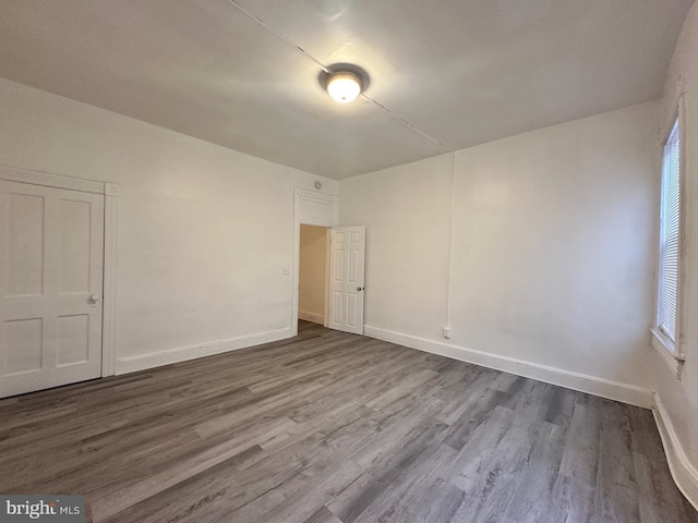 spare room featuring wood-type flooring