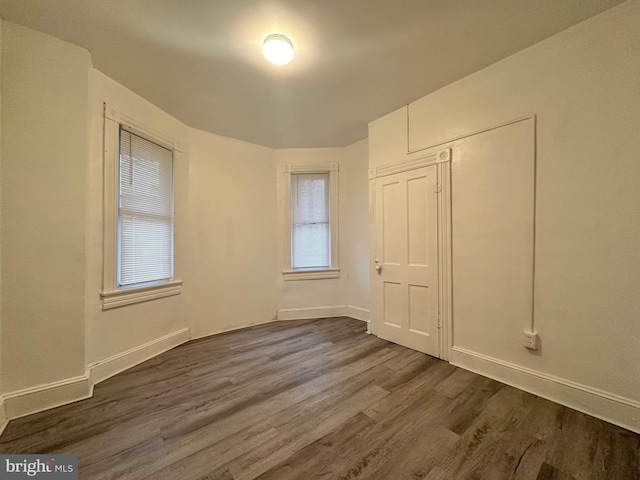 unfurnished bedroom featuring hardwood / wood-style floors and a closet