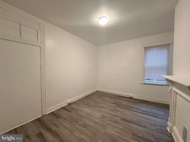 unfurnished room featuring dark hardwood / wood-style flooring