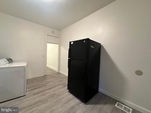 washroom featuring light wood-type flooring and washer and dryer