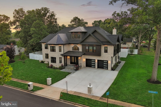 craftsman house featuring a garage and a lawn