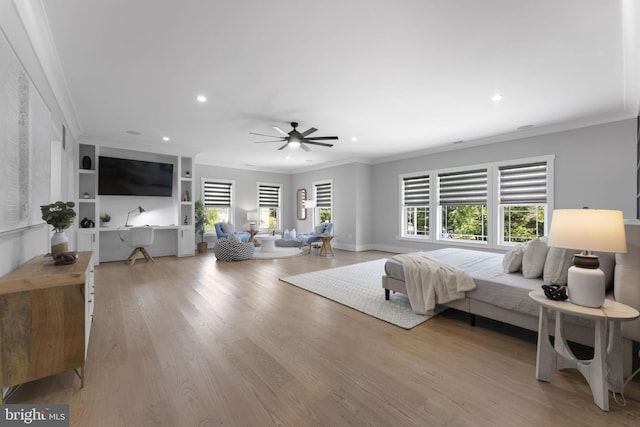 bedroom with crown molding, light hardwood / wood-style floors, and ceiling fan