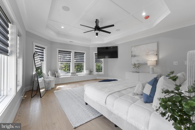 bedroom featuring coffered ceiling, ornamental molding, light hardwood / wood-style floors, and ceiling fan