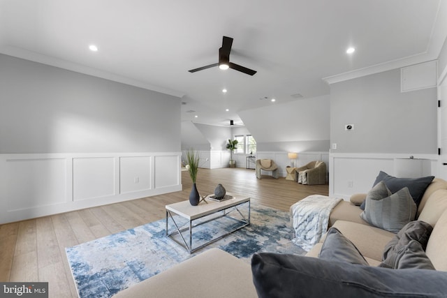 living room with crown molding, ceiling fan, and light hardwood / wood-style flooring