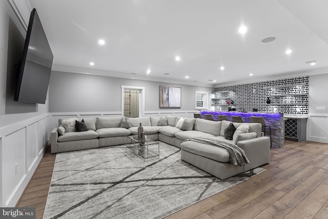 living room with ornamental molding and hardwood / wood-style floors