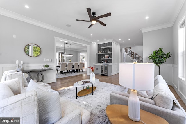 living room with crown molding, a wealth of natural light, and dark hardwood / wood-style flooring