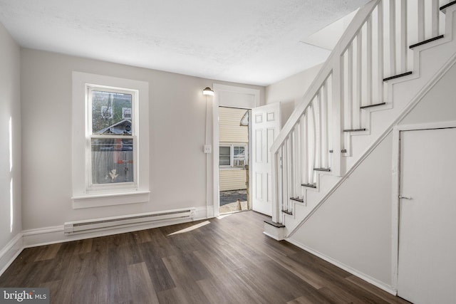 foyer featuring baseboard heating, a textured ceiling, and dark hardwood / wood-style flooring