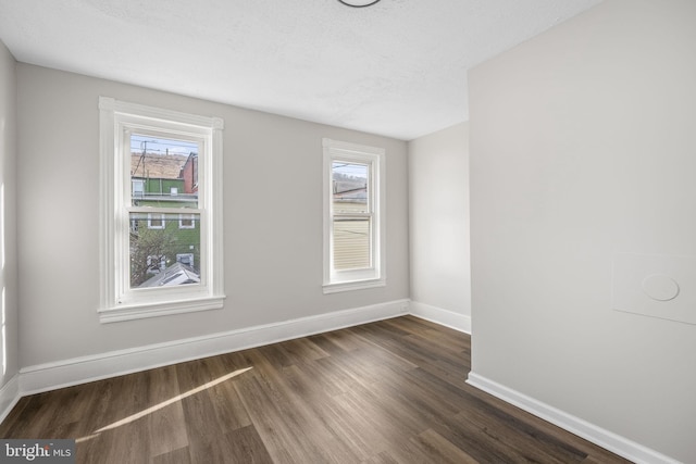 spare room featuring dark hardwood / wood-style floors