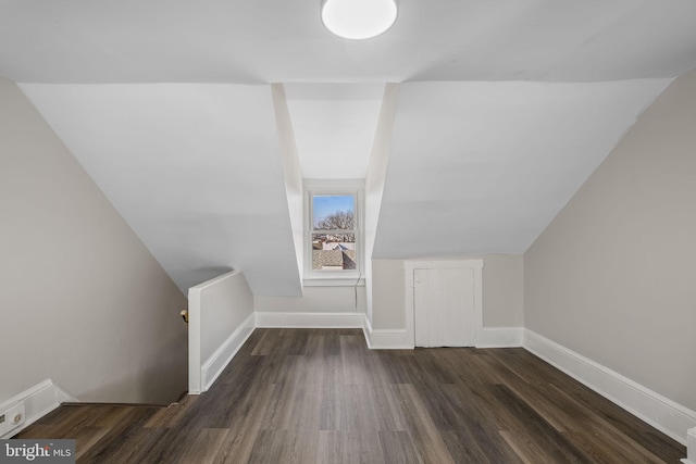 additional living space with dark hardwood / wood-style flooring and lofted ceiling