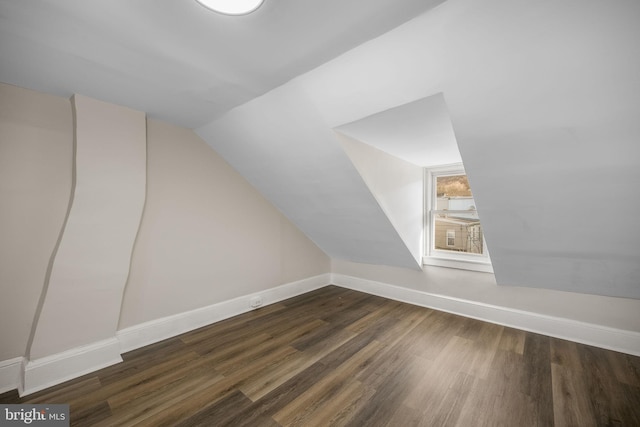 bonus room featuring vaulted ceiling and dark hardwood / wood-style floors