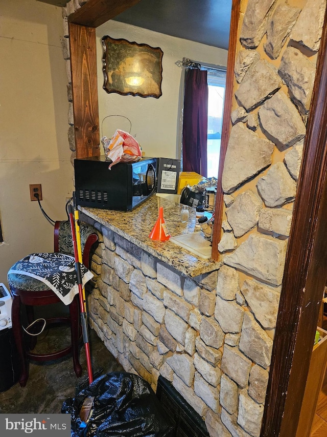 kitchen featuring stone counters