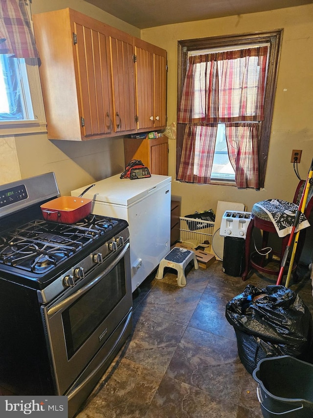 kitchen featuring stainless steel range with gas cooktop and refrigerator