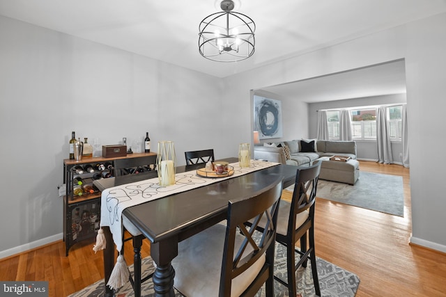 dining area featuring a notable chandelier and light hardwood / wood-style flooring