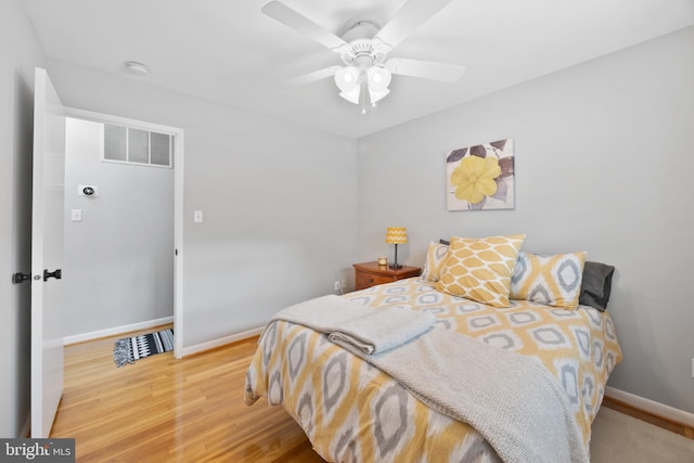 bedroom with hardwood / wood-style flooring and ceiling fan