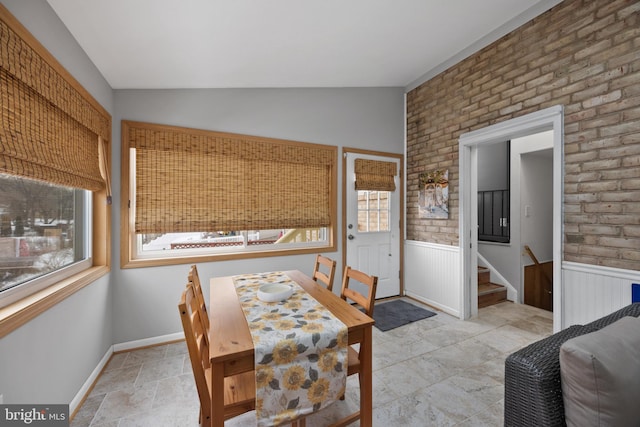 dining area featuring lofted ceiling