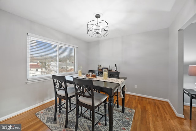 dining area featuring a notable chandelier and wood-type flooring