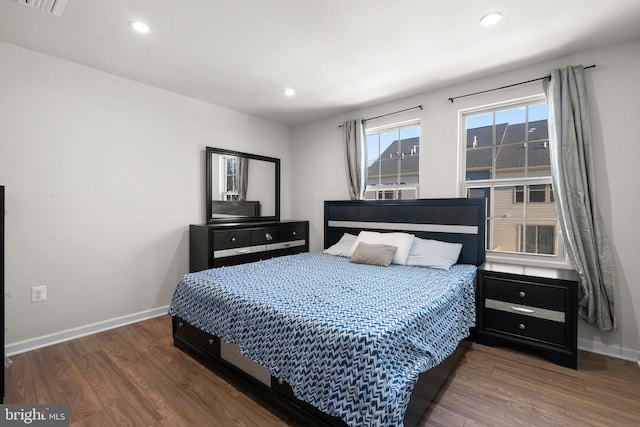 bedroom with dark wood-type flooring