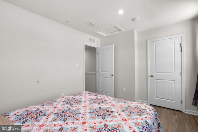 bedroom with dark hardwood / wood-style flooring