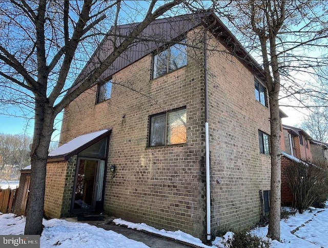 7140 Winter Rose Path, Columbia, MD 21045 - view of snow covered exterior featuring brick siding