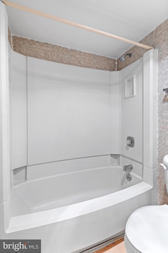 bathroom with shower / washtub combination and toilet