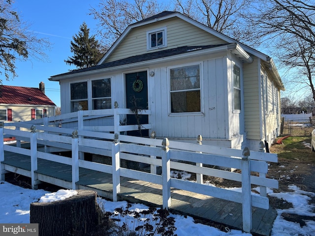 view of front of house featuring fence and a wooden deck