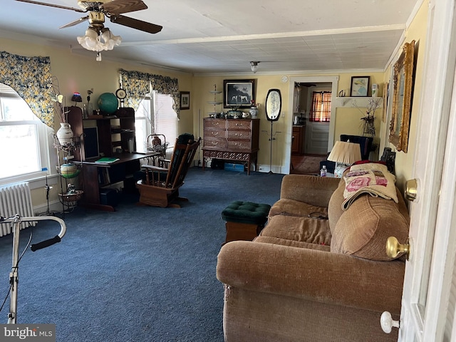 carpeted living room featuring radiator, baseboards, ornamental molding, and a ceiling fan