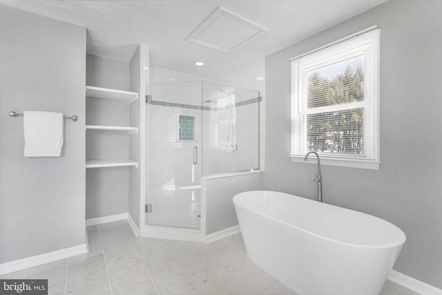 bathroom featuring a textured ceiling and shower with separate bathtub