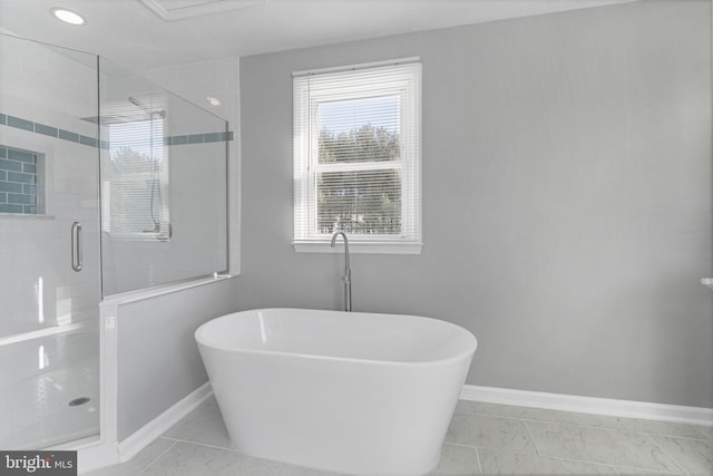 bathroom with tile patterned floors and shower with separate bathtub