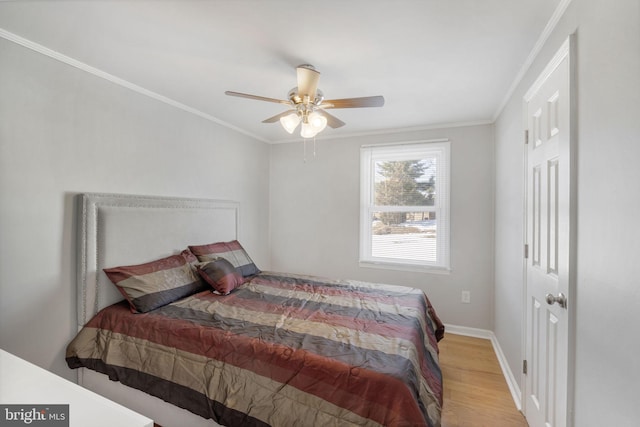 bedroom featuring ceiling fan, ornamental molding, and light hardwood / wood-style floors