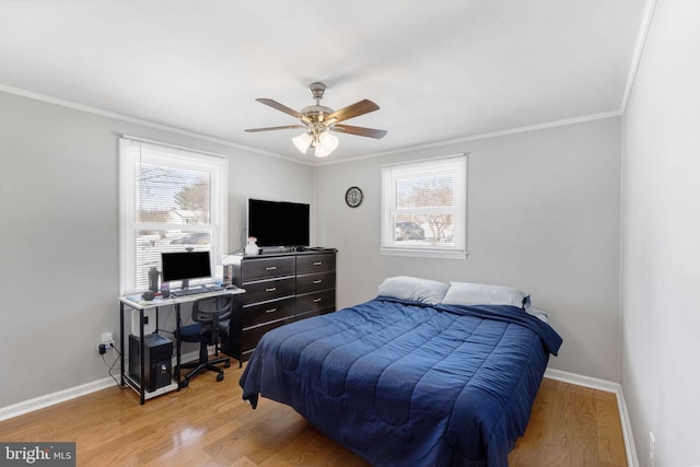 bedroom featuring ceiling fan, wood-type flooring, and multiple windows