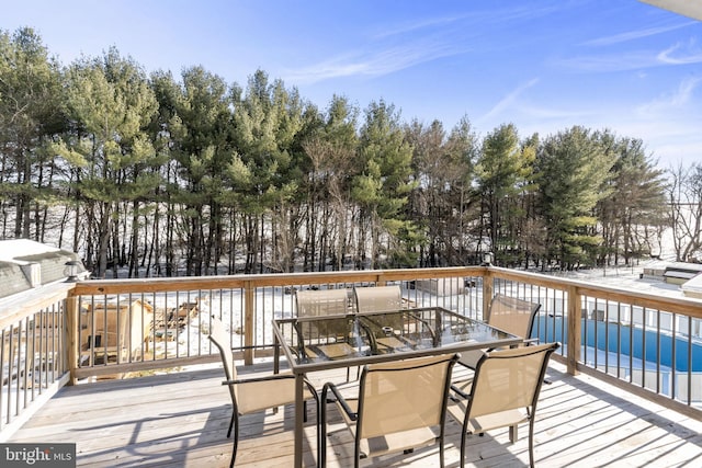 snow covered deck featuring a swimming pool