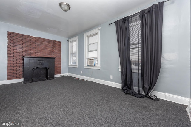 unfurnished living room with a brick fireplace and carpet