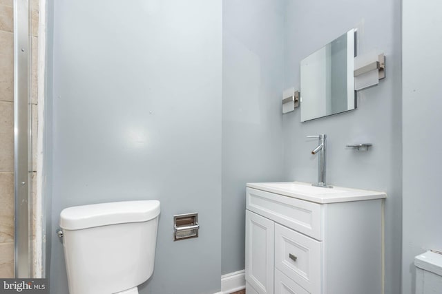 bathroom featuring toilet and vanity