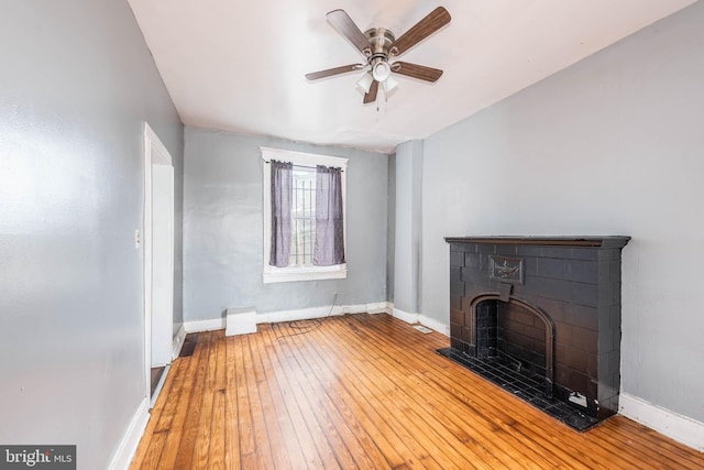 unfurnished living room with ceiling fan and hardwood / wood-style flooring