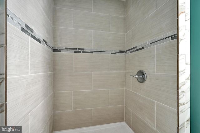 bathroom with a tile shower