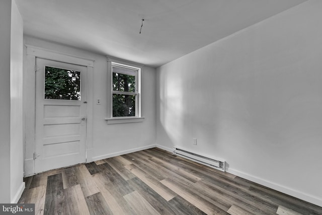 foyer with hardwood / wood-style flooring and baseboard heating