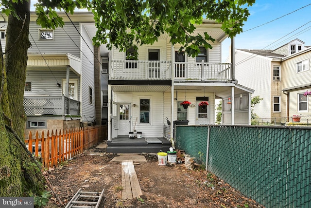 back of property with a balcony