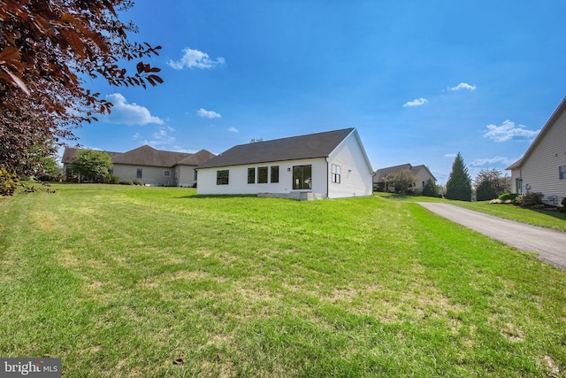 back of house with a lawn