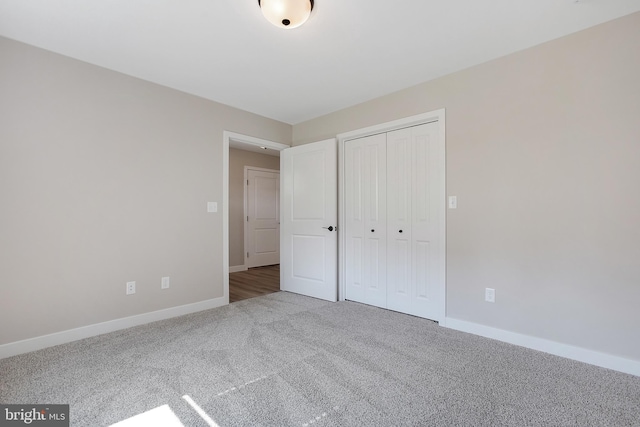 unfurnished bedroom featuring a closet and carpet