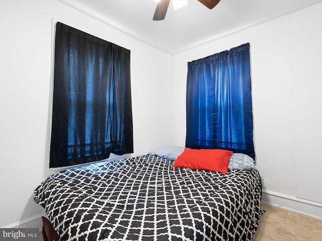 bedroom with ceiling fan and carpet floors