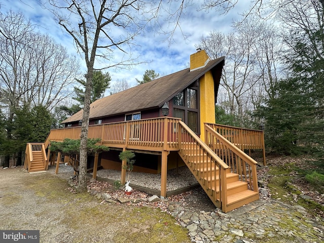 rear view of house with a wooden deck