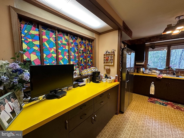 office area with brick wall and sink