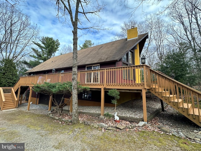 back of property featuring a deck