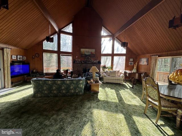 carpeted living room with beamed ceiling, high vaulted ceiling, wood ceiling, and wooden walls