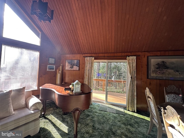 carpeted office space featuring wood walls, a healthy amount of sunlight, vaulted ceiling, and wooden ceiling