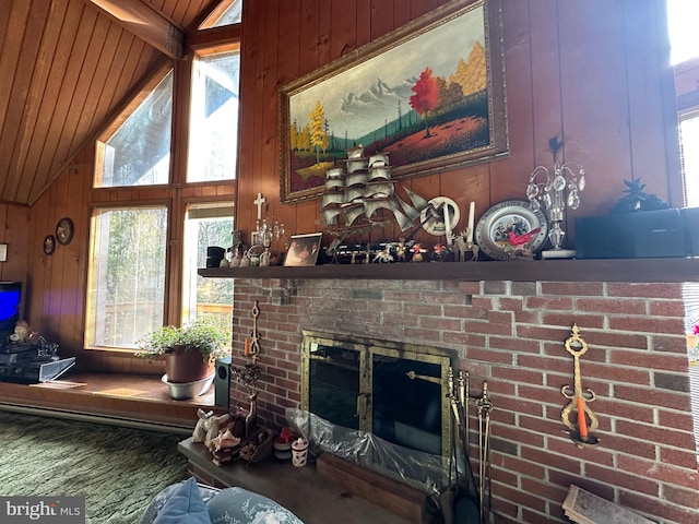 living room with a fireplace, lofted ceiling with beams, and wooden walls