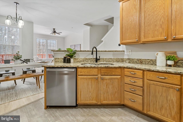 kitchen with ceiling fan with notable chandelier, sink, light stone counters, and dishwasher